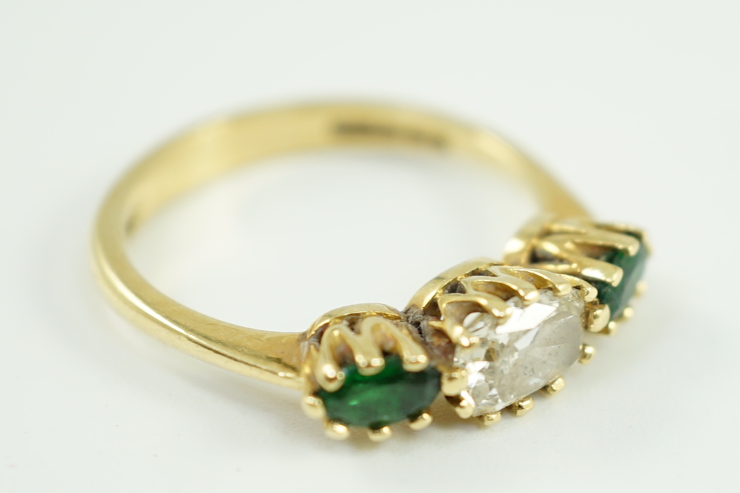 A modern 18ct gold, diamond and green tourmaline set three stone ring